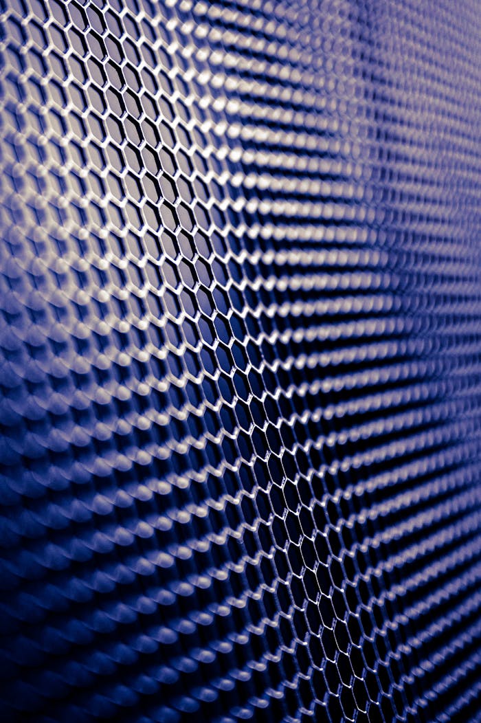 gallery-3 Close-up of a futuristic metallic hexagonal pattern, perfect for tech designs.